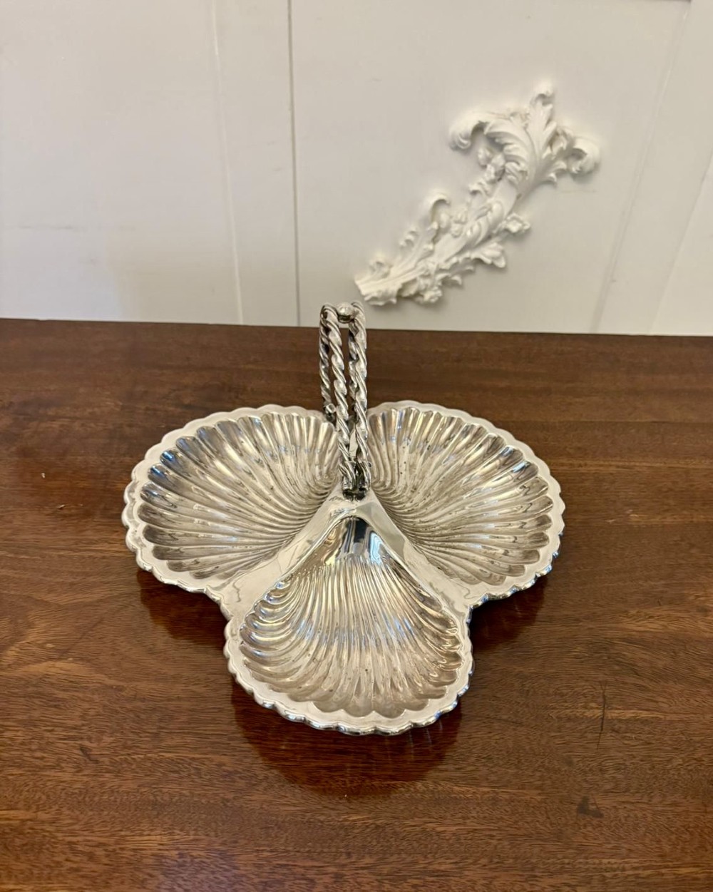 An Edwardian silver-plated tripartite serving dish featuring three fluted shell-shaped compartments joined by a central twisted handle. View VII