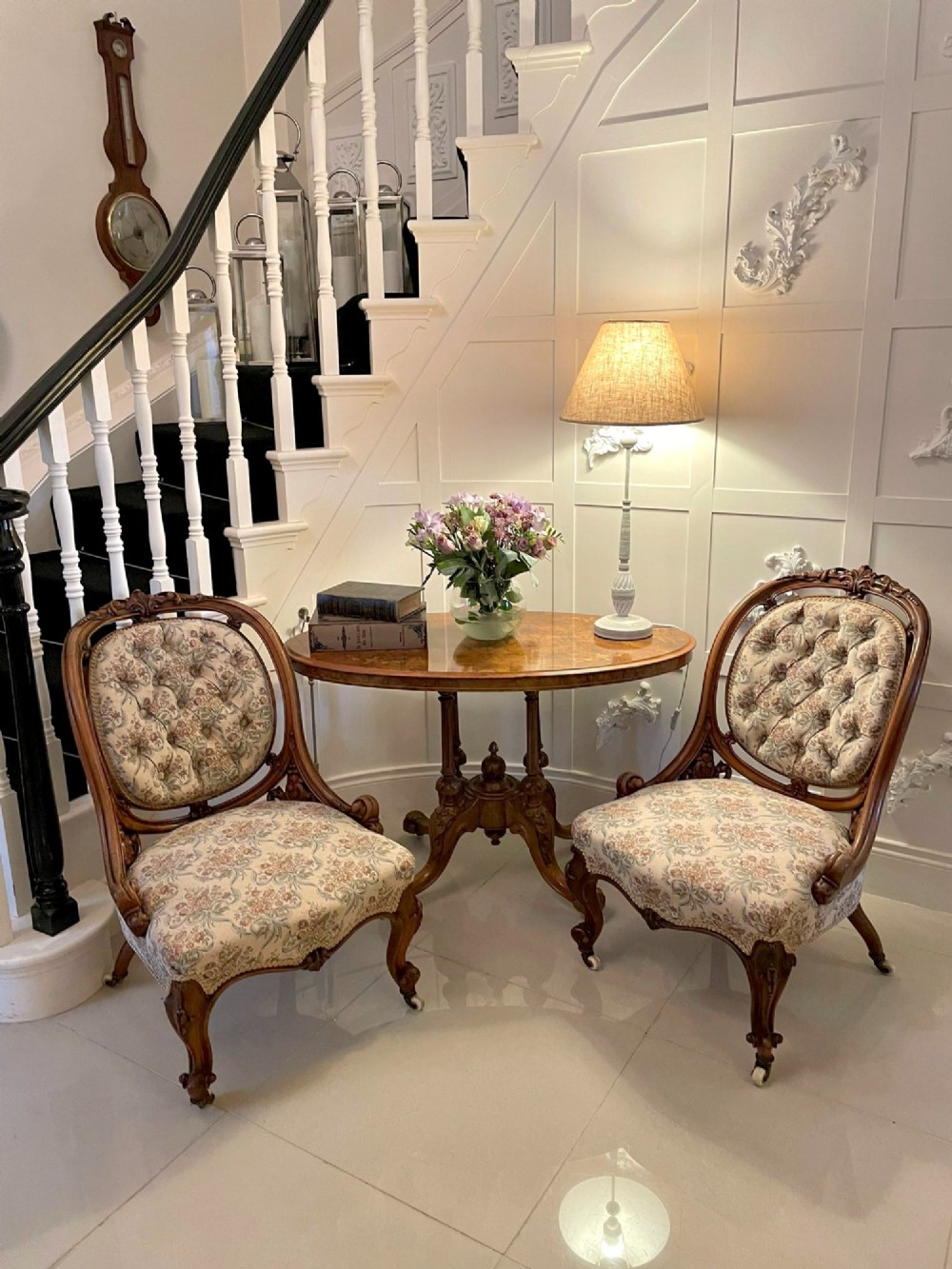 A pair of Victorian carved walnut side chairs featuring button-tufted floral upholstery and cabriole legs with ceramic castors. View VII