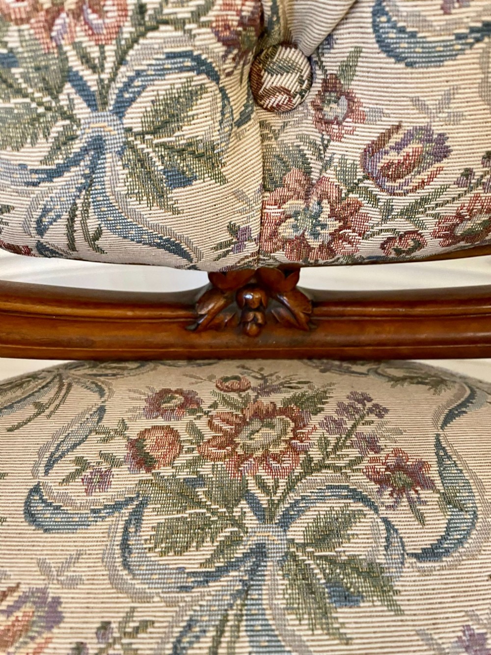 A pair of Victorian carved walnut side chairs featuring button-tufted floral upholstery and cabriole legs with ceramic castors. View XI