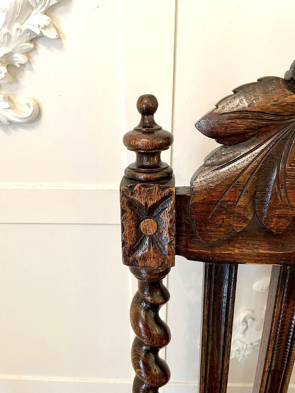A high-backed Victorian carved oak armchair featuring barley twist supports, acanthus leaf carvings, and a burgundy leather seat with brass stud detail. View VIII