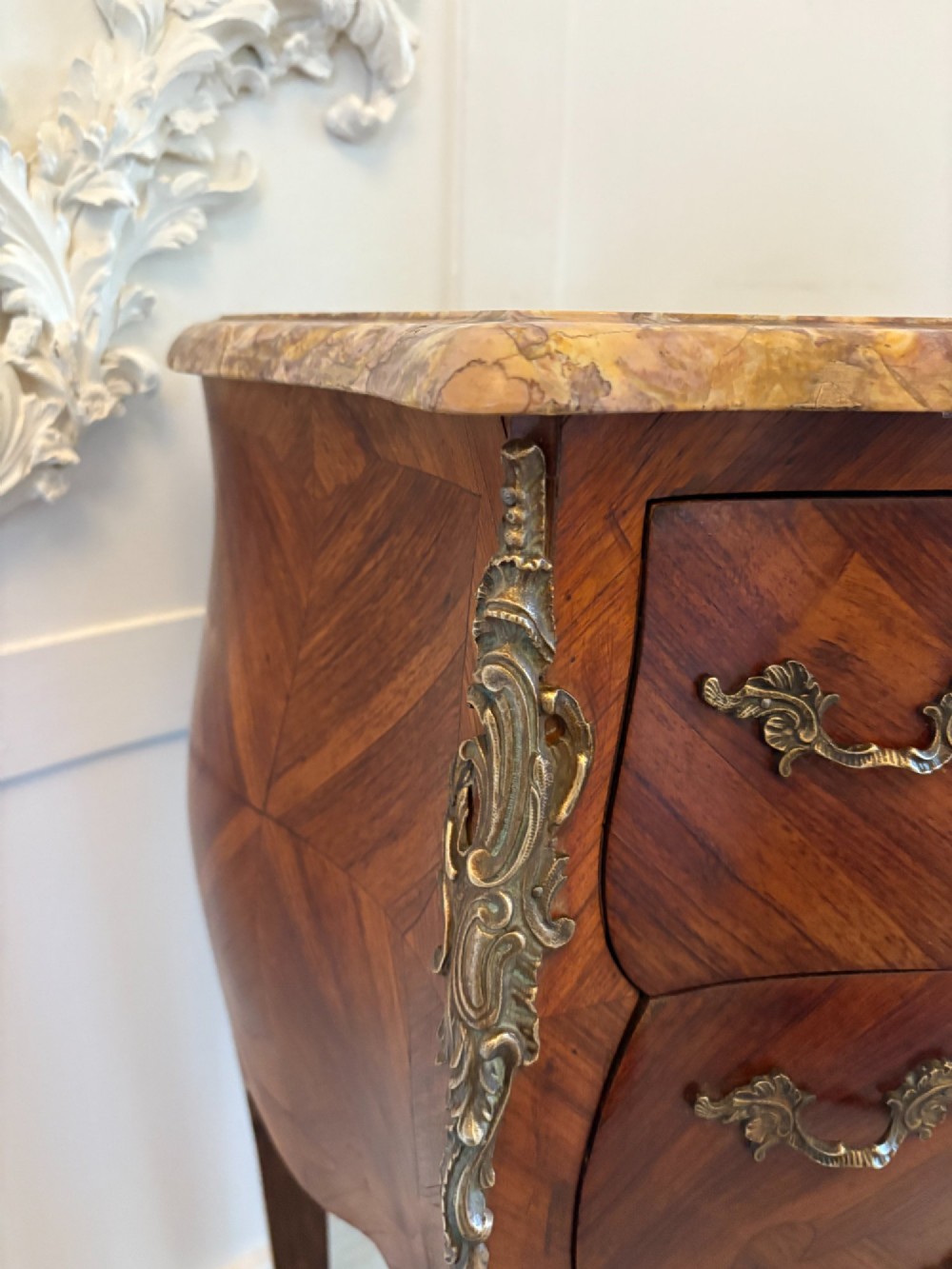 A pair of French Louis XV style kingwood bedside cabinets featuring two drawers, marquetry inlay, gilt bronze mounts, and serpentine marble tops. View XI