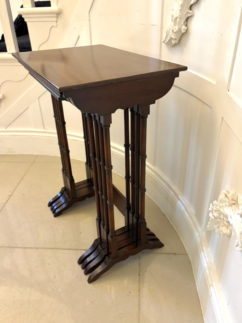 A set of four graduated Edwardian mahogany nesting tables featuring fine satinwood inlay borders and slender turned legs on trestle feet. View XI