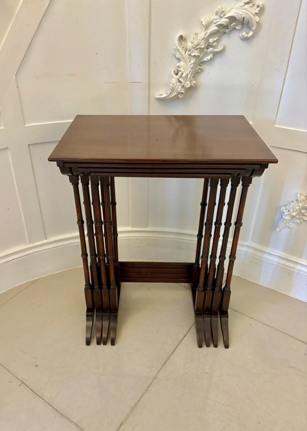 A set of four graduated Edwardian mahogany nesting tables featuring fine satinwood inlay borders and slender turned legs on trestle feet. View XII