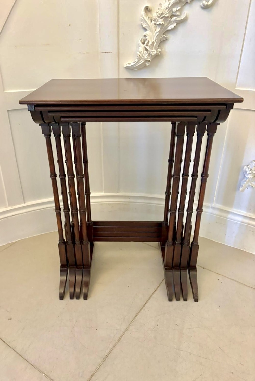 A set of four graduated Edwardian mahogany nesting tables featuring fine satinwood inlay borders and slender turned legs on trestle feet. View XIII