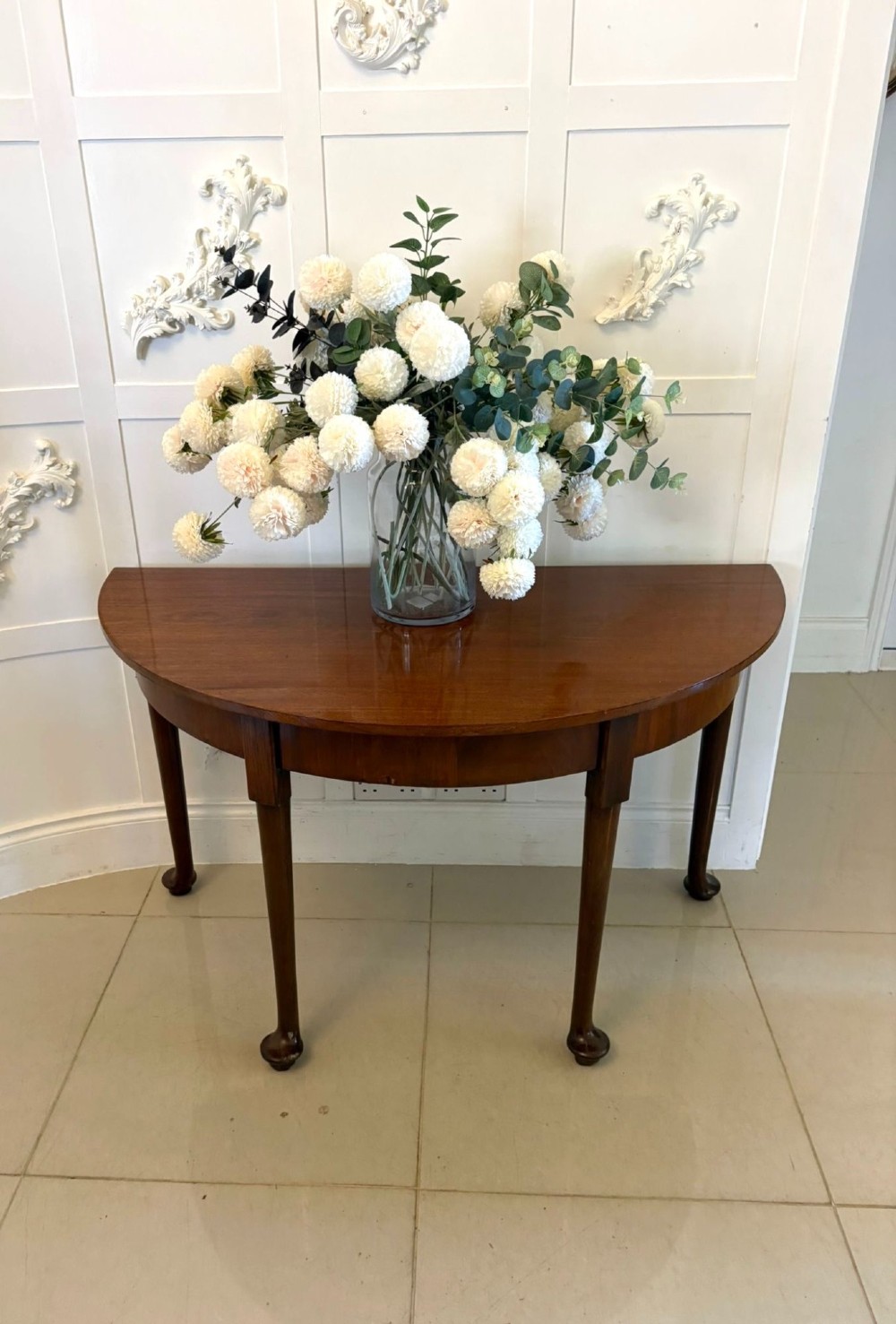 A large extended Georgian mahogany dining table featuring curved D-shaped ends, polished figure top, and slender legs with pad feet. View IV