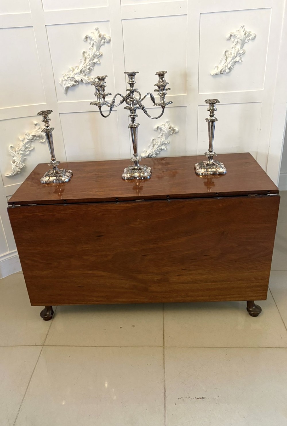 A large extended Georgian mahogany dining table featuring curved D-shaped ends, polished figure top, and slender legs with pad feet. View XIII