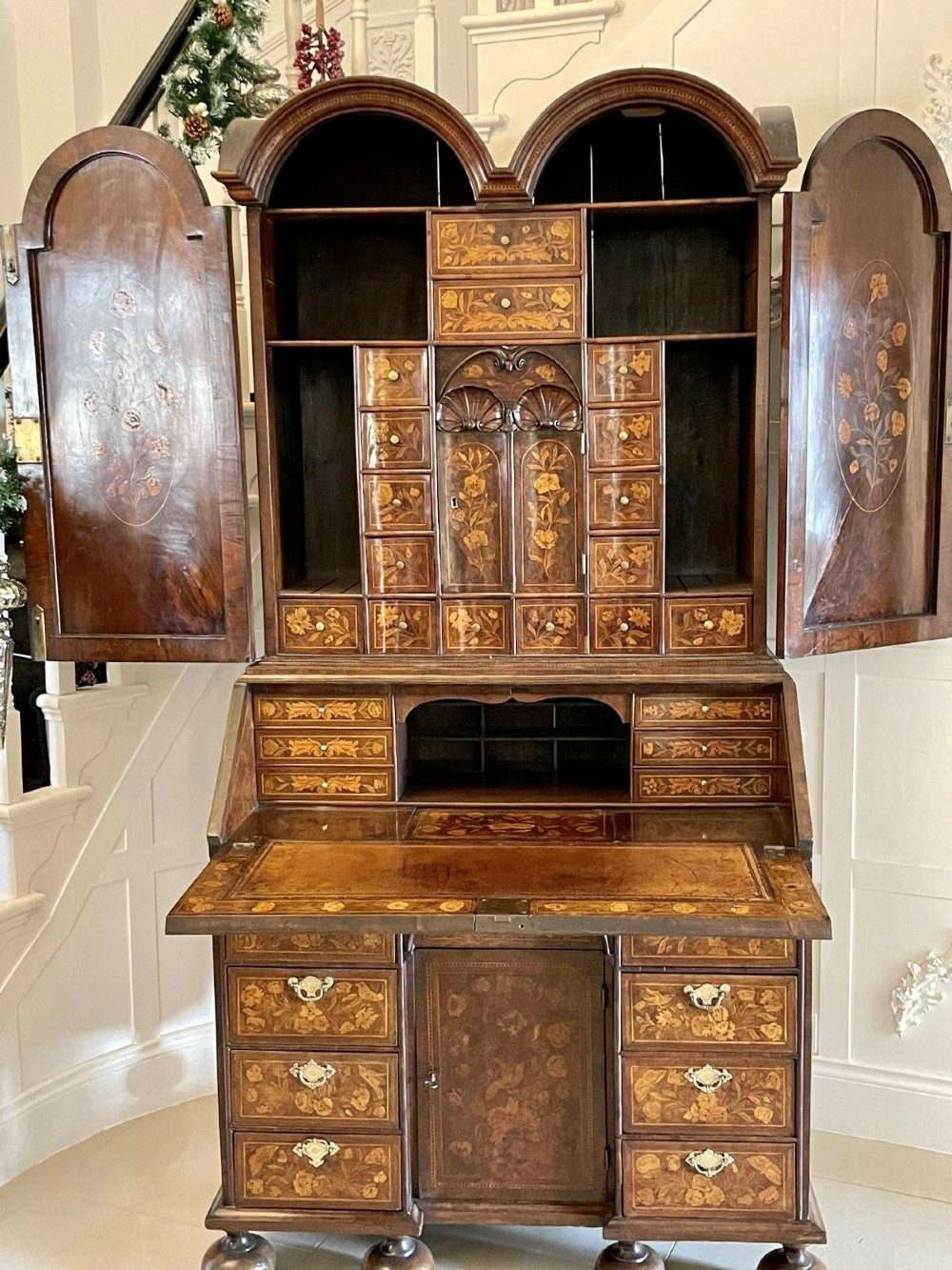 An antique William and Mary double-dome bureau bookcase crafted from burr walnut with intricate floral marquetry inlay and ball feet. View II