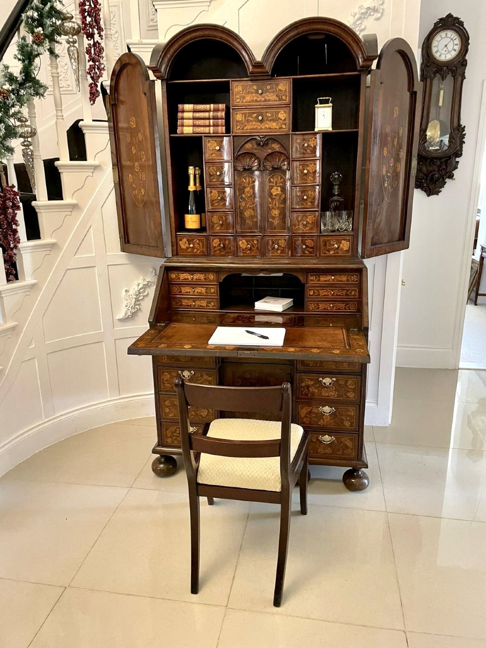 An antique William and Mary double-dome bureau bookcase crafted from burr walnut with intricate floral marquetry inlay and ball feet. View III