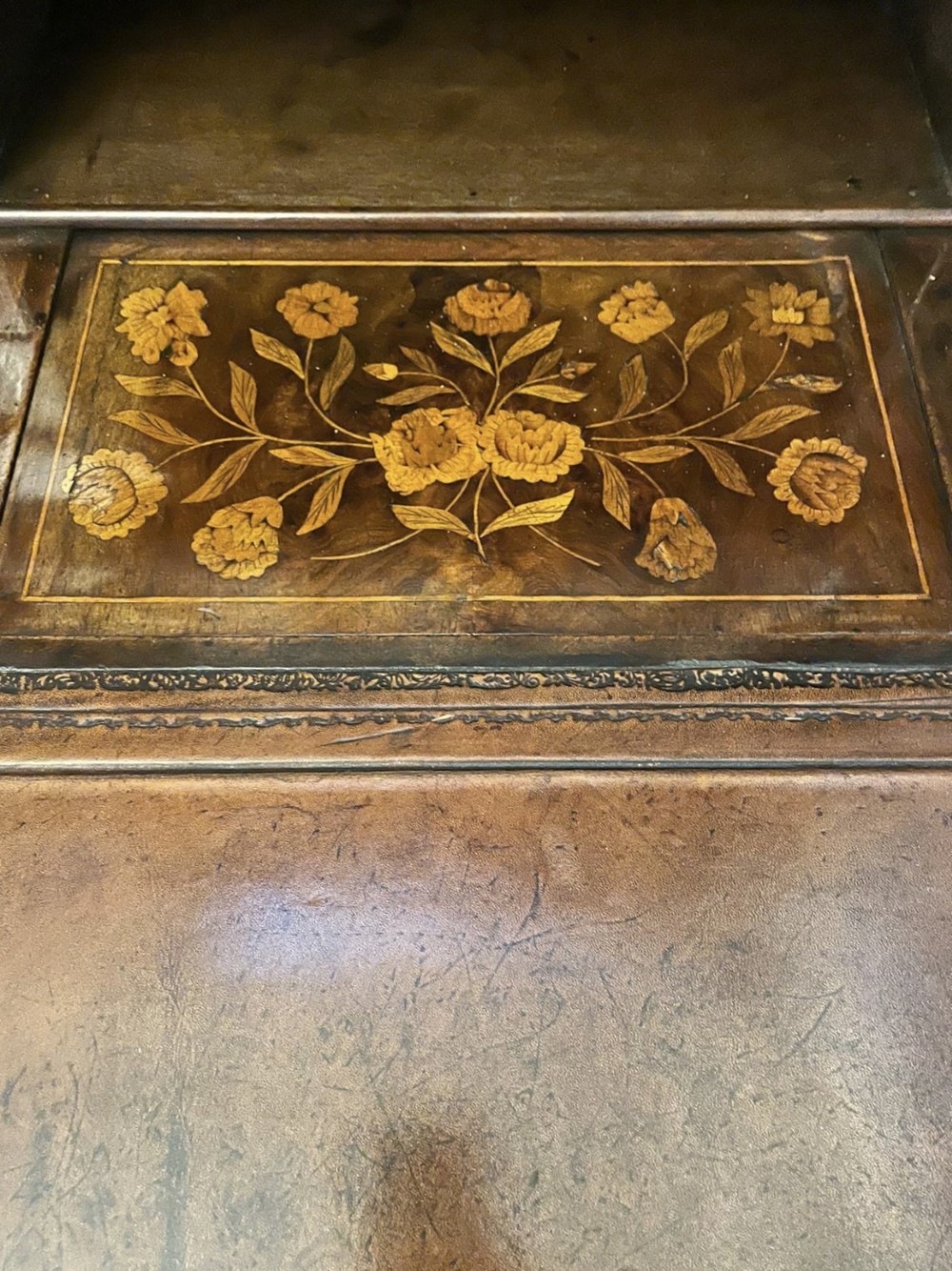 An antique William and Mary double-dome bureau bookcase crafted from burr walnut with intricate floral marquetry inlay and ball feet. View IV