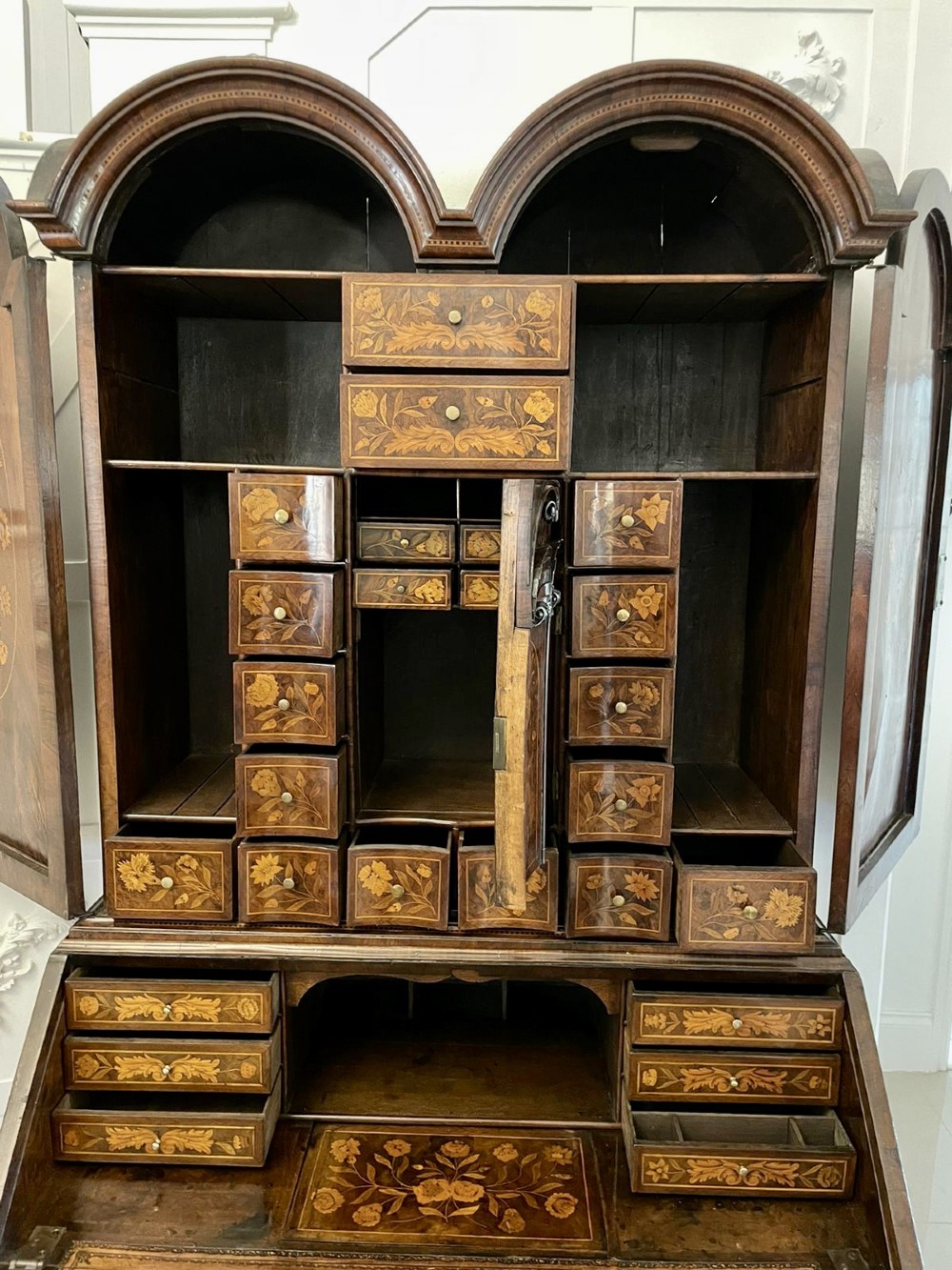 An antique William and Mary double-dome bureau bookcase crafted from burr walnut with intricate floral marquetry inlay and ball feet. View V