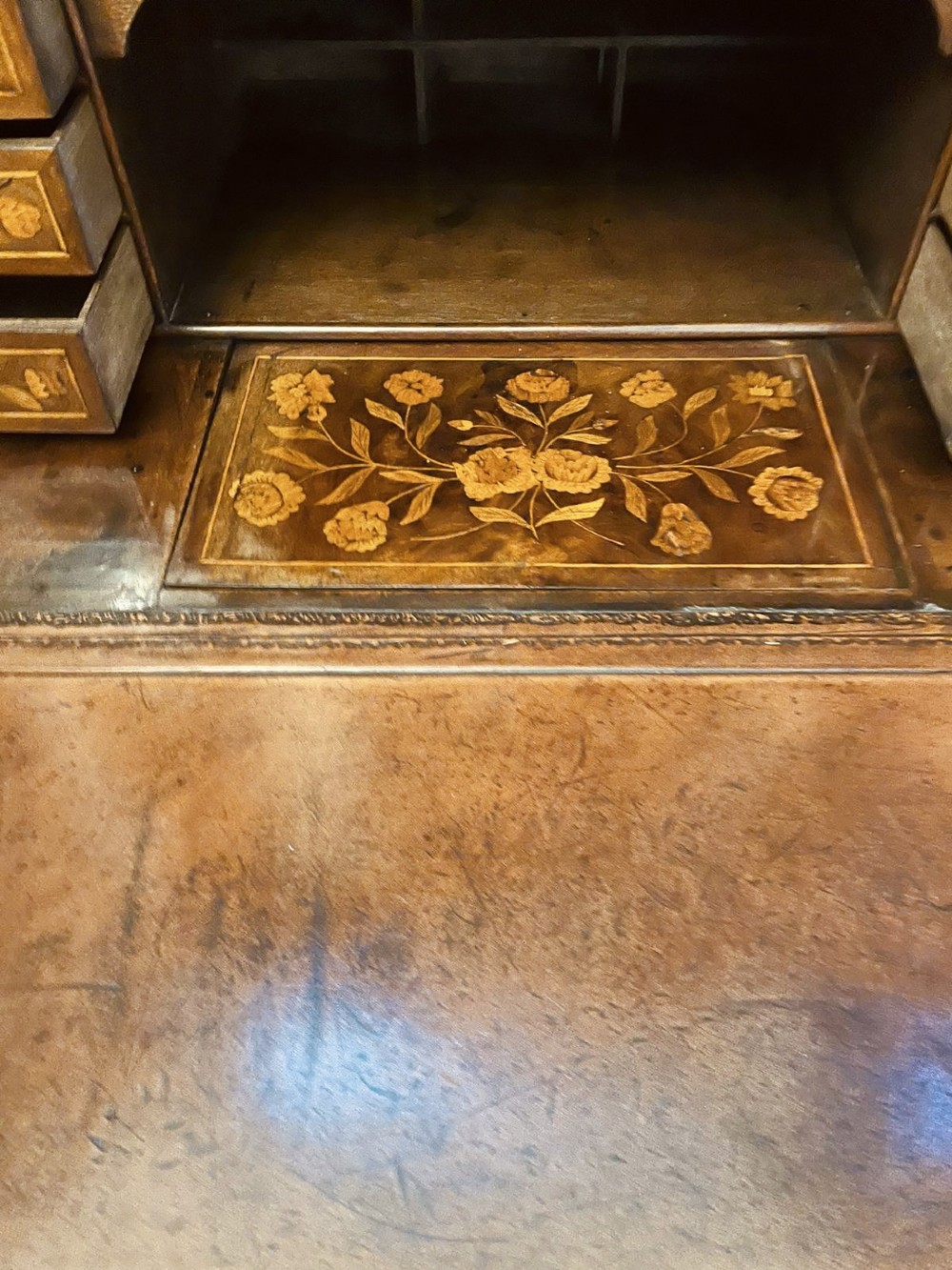 An antique William and Mary double-dome bureau bookcase crafted from burr walnut with intricate floral marquetry inlay and ball feet. View VIII