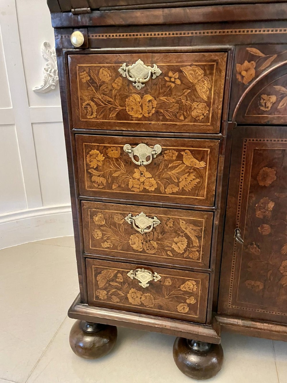 An antique William and Mary double-dome bureau bookcase crafted from burr walnut with intricate floral marquetry inlay and ball feet. View IX