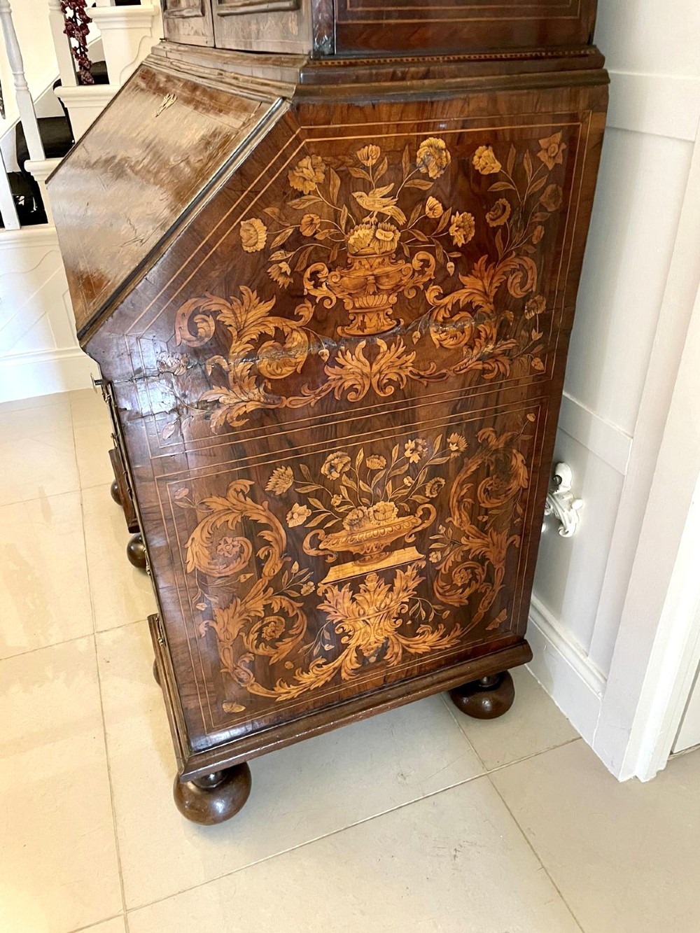 An antique William and Mary double-dome bureau bookcase crafted from burr walnut with intricate floral marquetry inlay and ball feet. View X