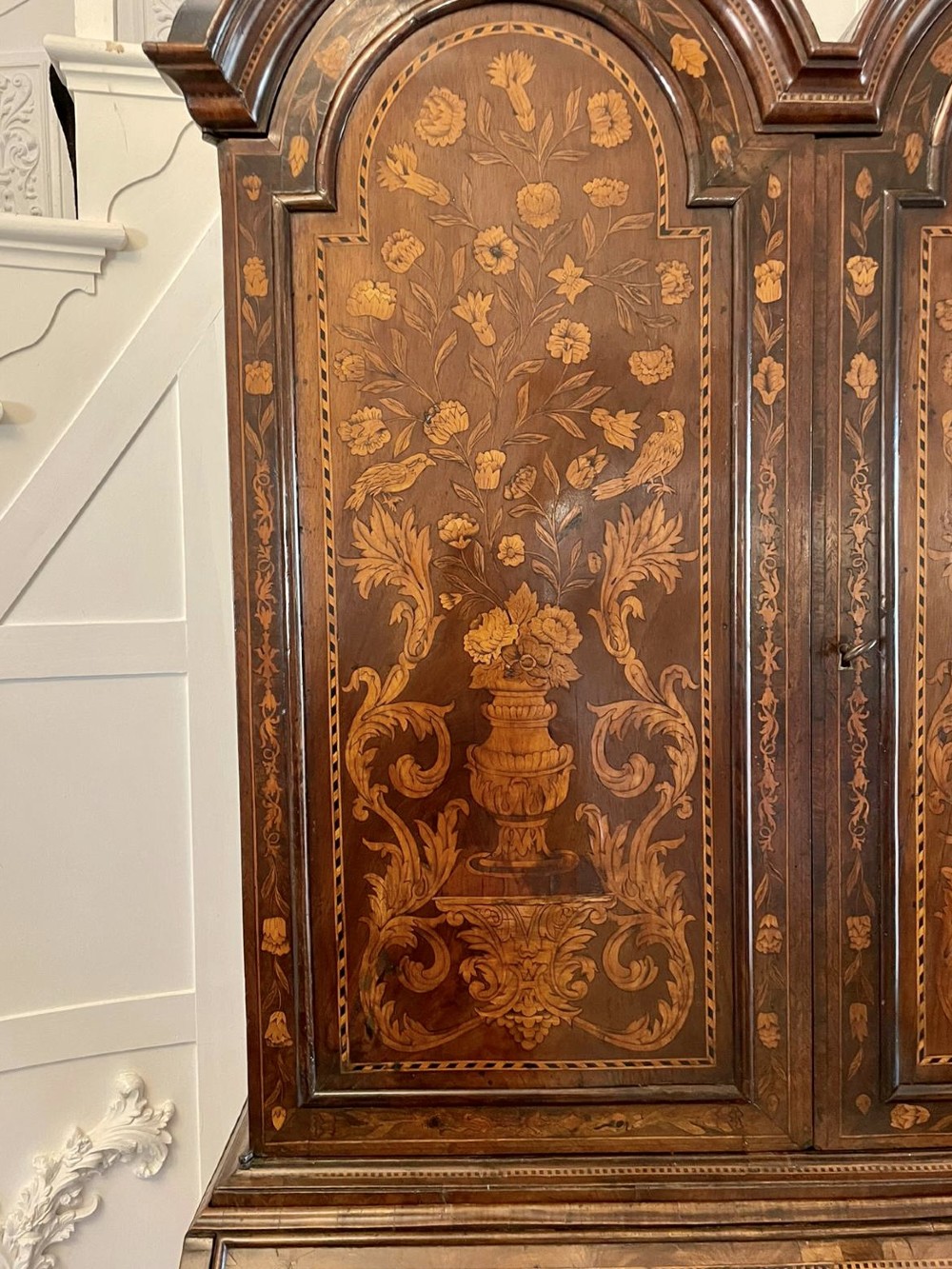 An antique William and Mary double-dome bureau bookcase crafted from burr walnut with intricate floral marquetry inlay and ball feet. View XII