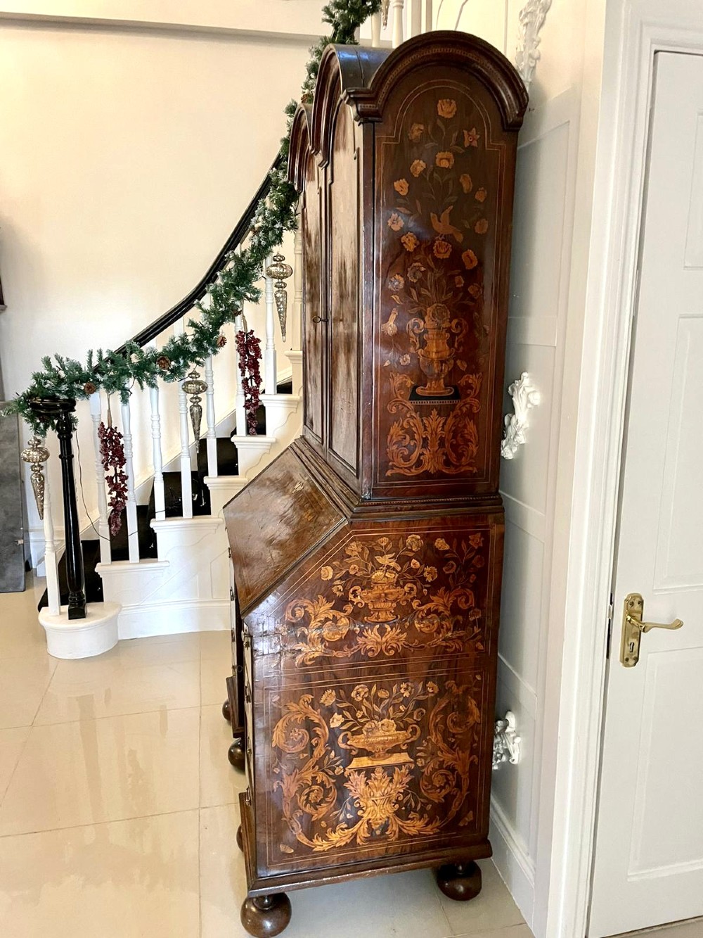 An antique William and Mary double-dome bureau bookcase crafted from burr walnut with intricate floral marquetry inlay and ball feet. View XIII