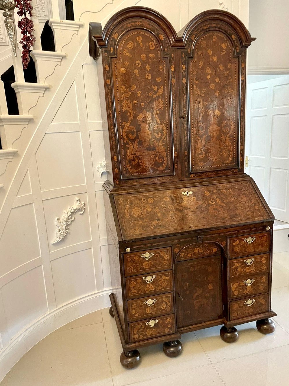 An antique William and Mary double-dome bureau bookcase crafted from burr walnut with intricate floral marquetry inlay and ball feet. View XIV