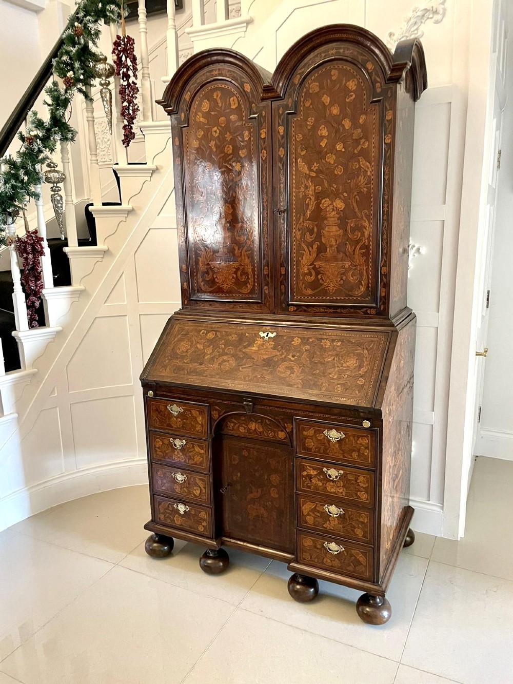 An antique William and Mary double-dome bureau bookcase crafted from burr walnut with intricate floral marquetry inlay and ball feet. View XV