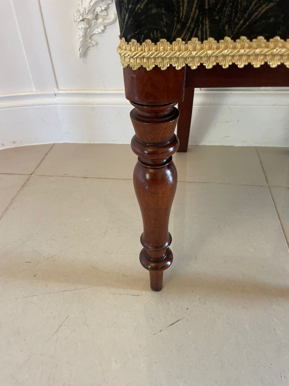 A set of ten Victorian mahogany dining chairs with curved crest rails, turned front legs, and dark pattern upholstered seats. View XII