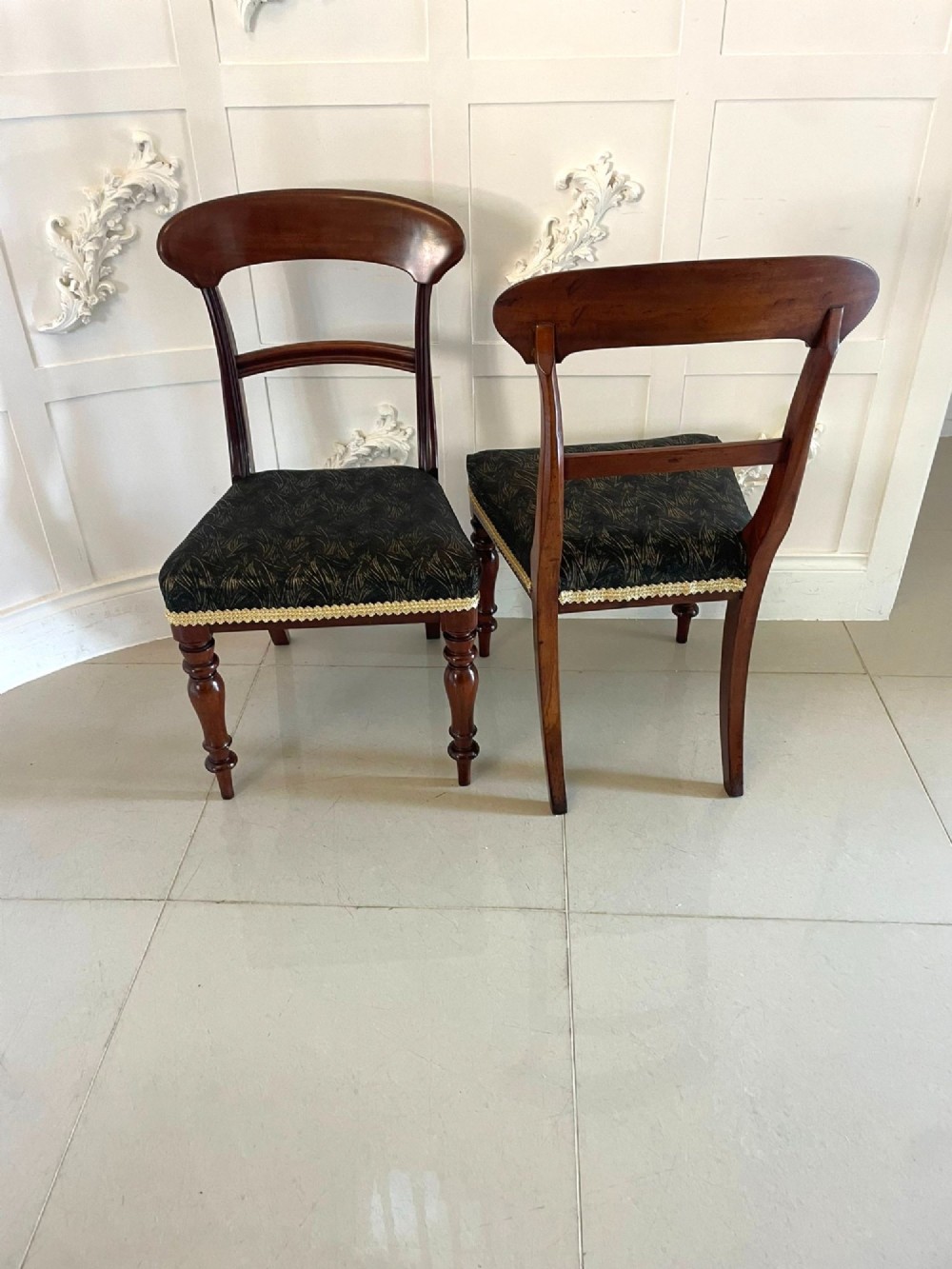 A set of ten Victorian mahogany dining chairs with curved crest rails, turned front legs, and dark pattern upholstered seats. View XIII
