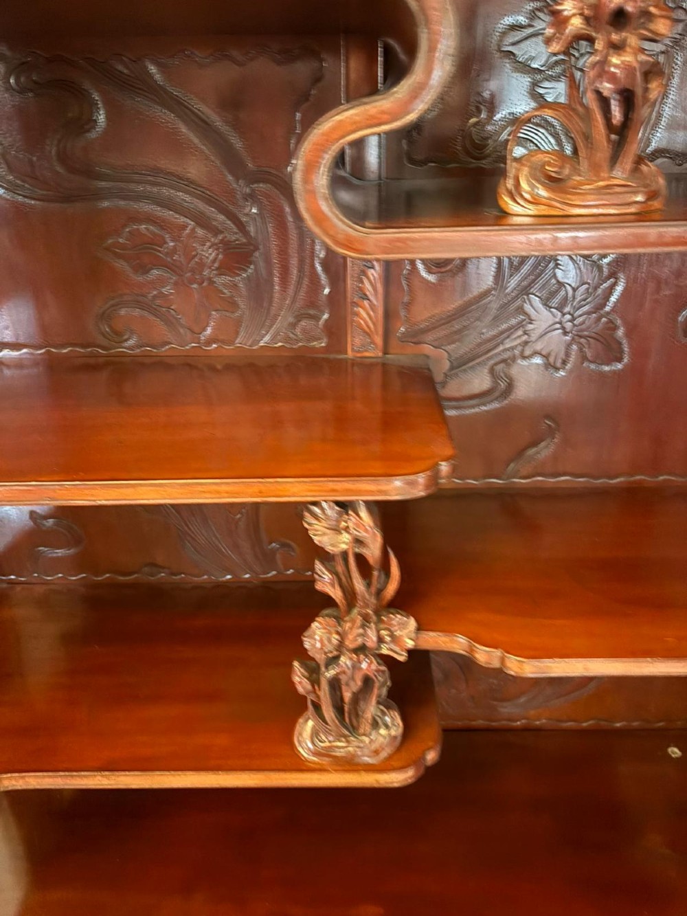 A carved reddish-brown hardwood display cabinet featuring a pagoda cresting, glass door, asymmetrical interior shelves, lower drawers, and cabriole legs. View VI