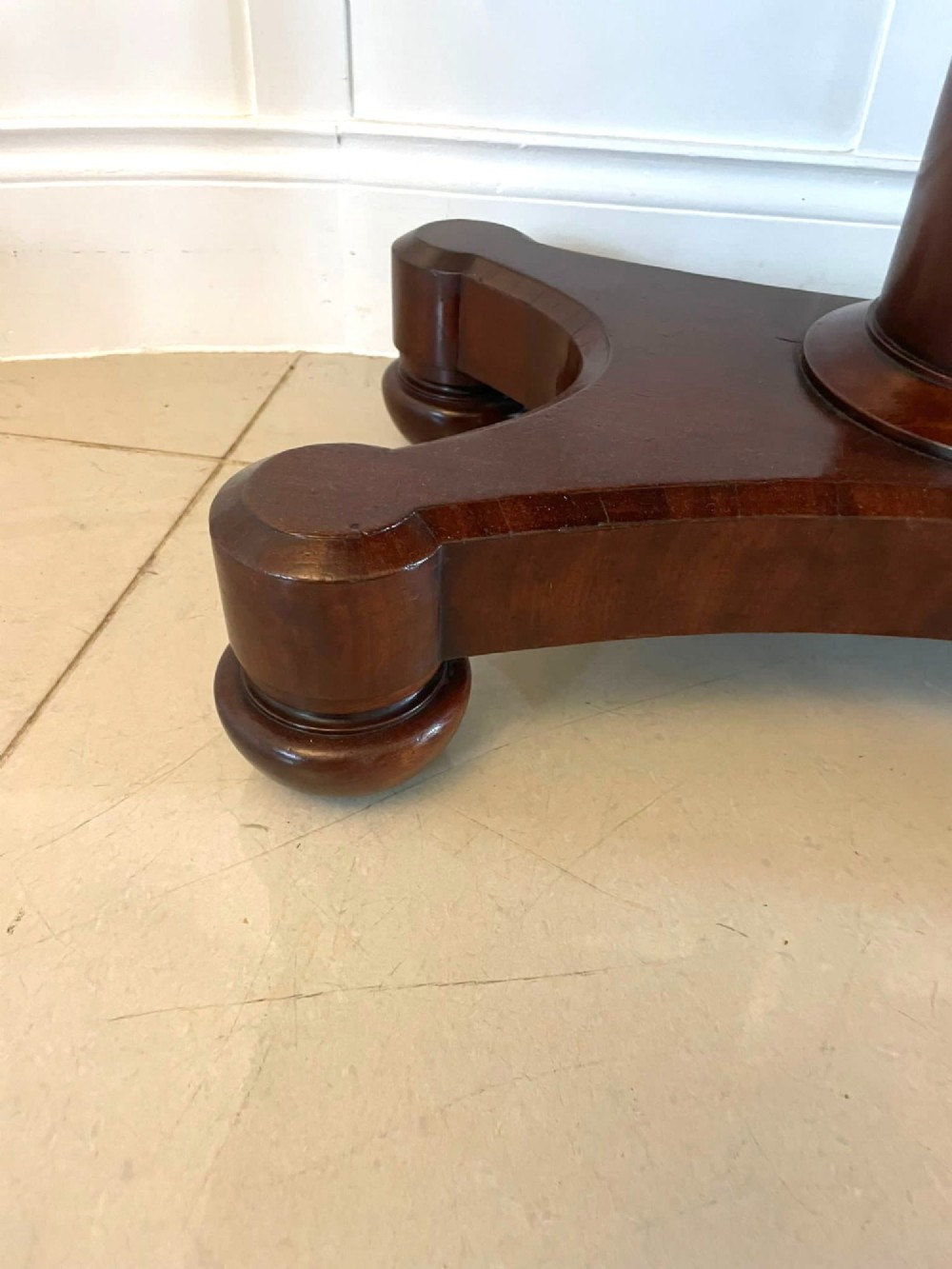 A Victorian mahogany card table featuring a rectangular fold-over top, carved scroll apron brackets, and a central cylindrical pedestal on a four-point plinth base. View VIII