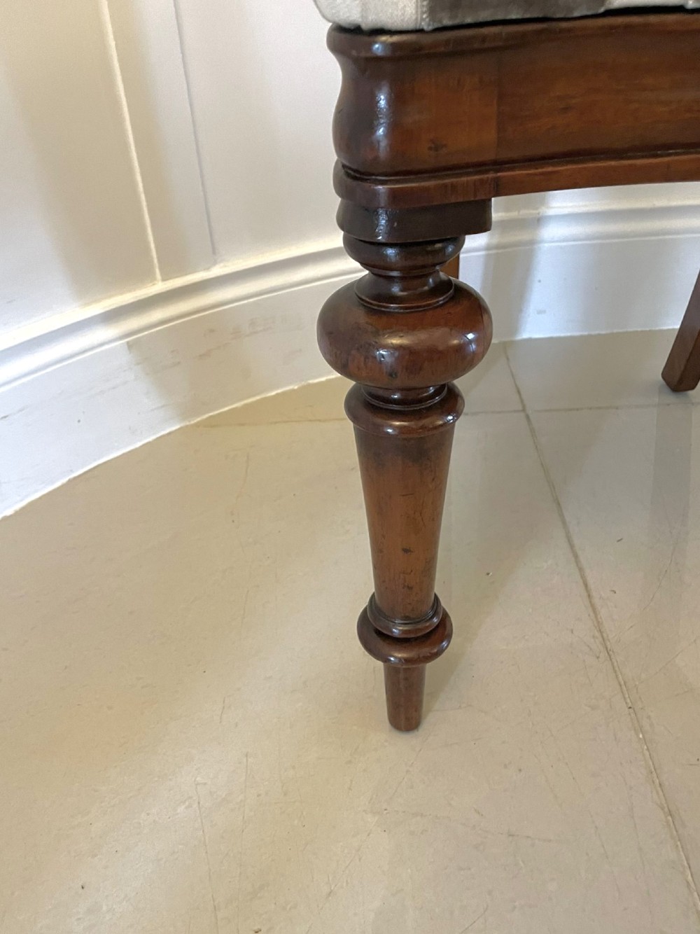 A set of six Victorian mahogany dining chairs featuring rounded balloon backrests, carved mid-rails, patterned upholstery, and turned front legs. View V