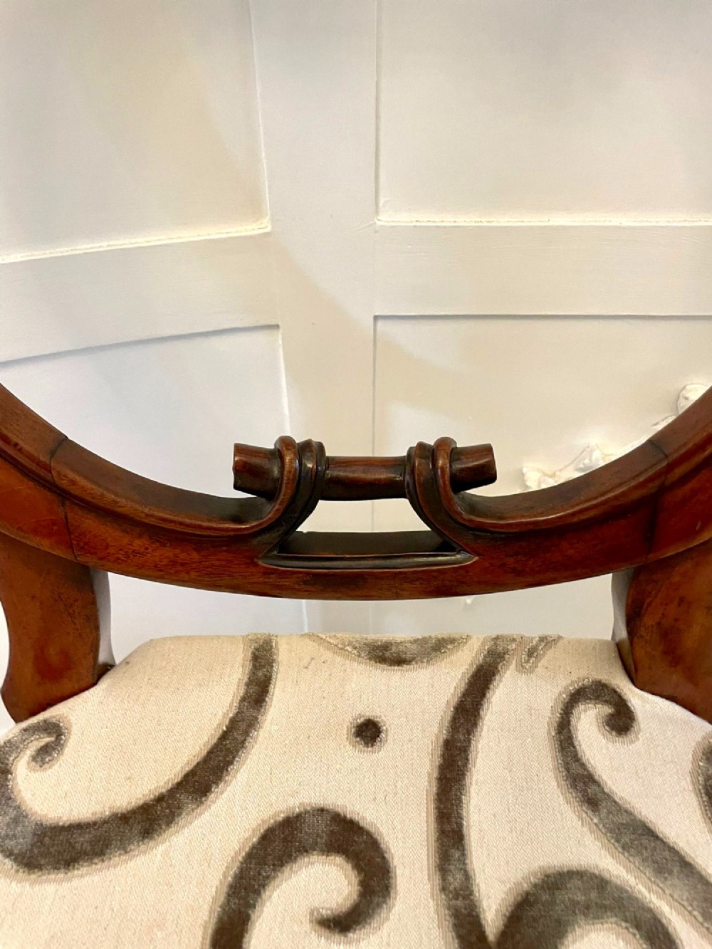 A set of six Victorian mahogany dining chairs featuring rounded balloon backrests, carved mid-rails, patterned upholstery, and turned front legs. View VI