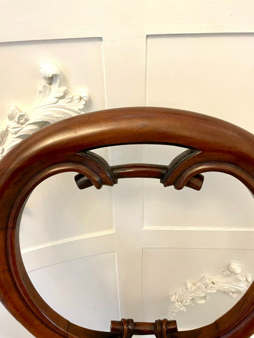 A set of six Victorian mahogany dining chairs featuring rounded balloon backrests, carved mid-rails, patterned upholstery, and turned front legs. View VII