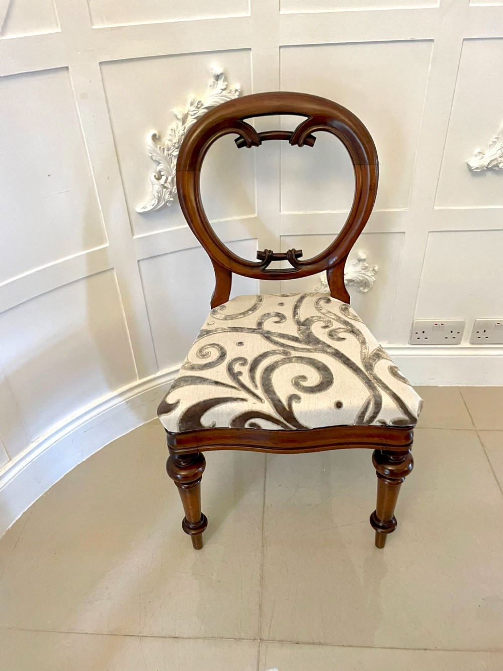A set of six Victorian mahogany dining chairs featuring rounded balloon backrests, carved mid-rails, patterned upholstery, and turned front legs. View VIII