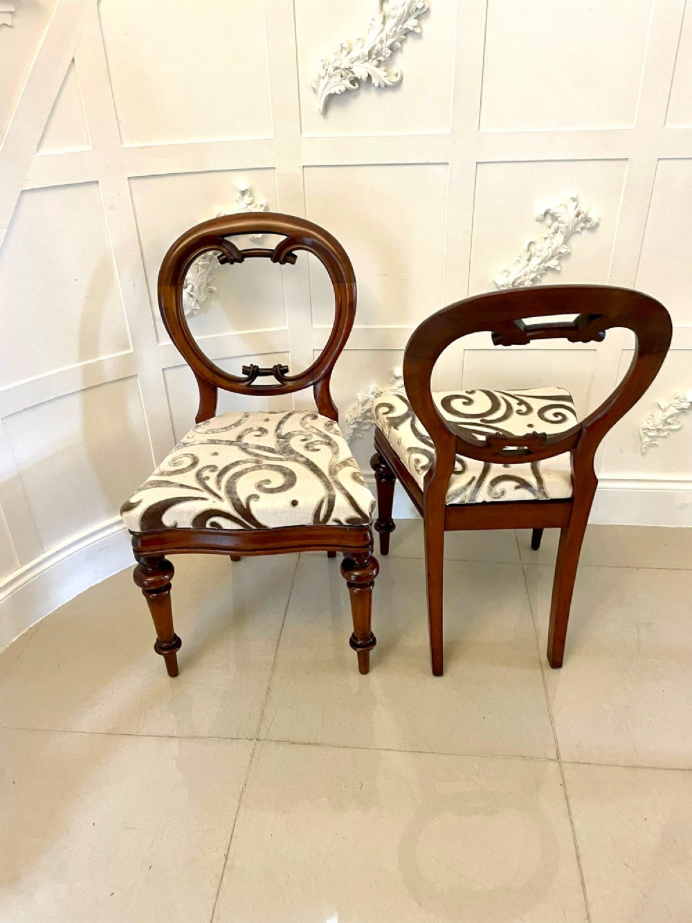 A set of six Victorian mahogany dining chairs featuring rounded balloon backrests, carved mid-rails, patterned upholstery, and turned front legs. View IX