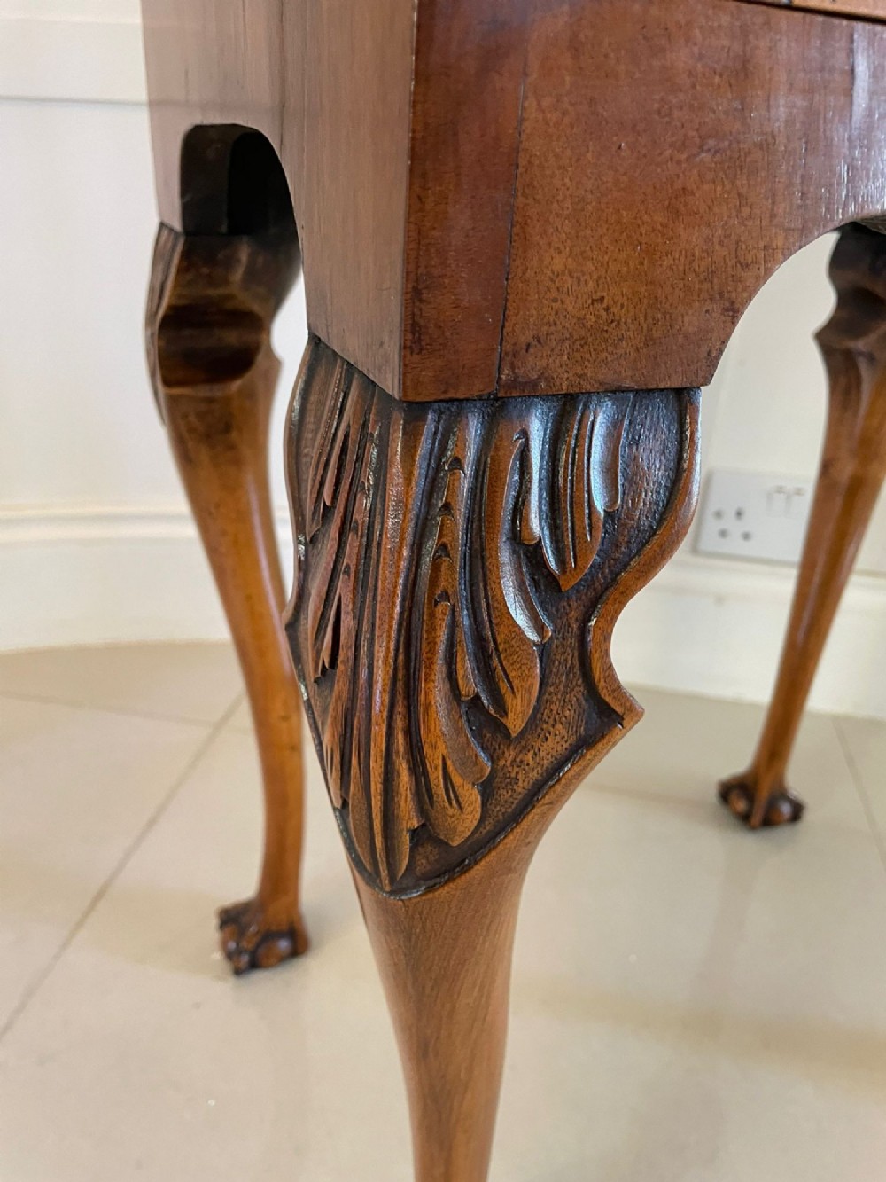 An antique burr walnut slant-front bureau featuring central floral marquetry inlay, two drawers, and carved cabriole legs with claw and ball feet. View VIII