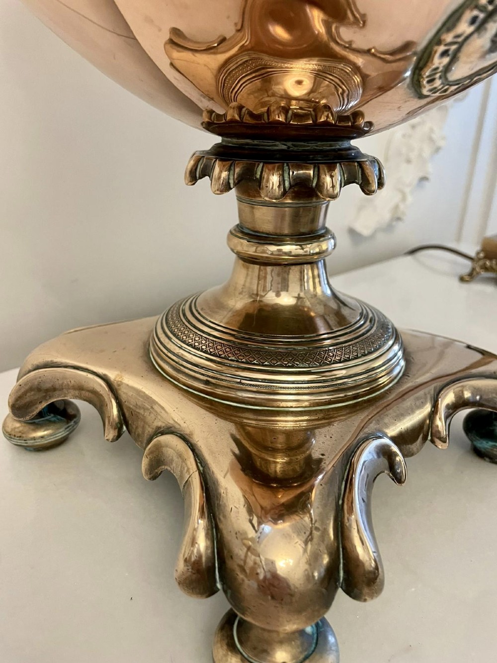 An antique Victorian polished copper and brass samovar featuring cast scrolling handles, a fluted top lid, a front tap, and a stepped square base. View II