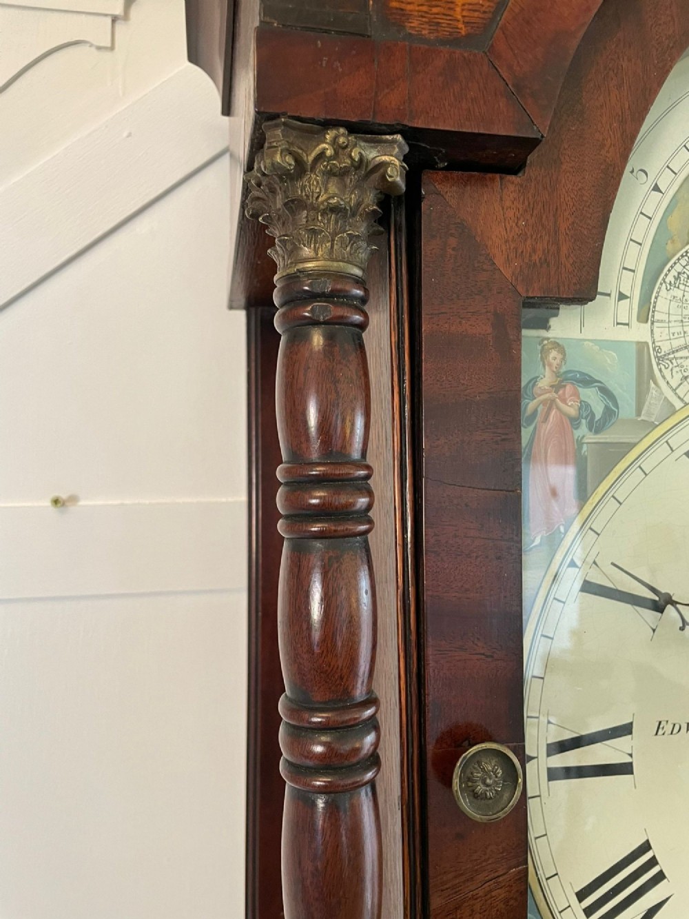 An antique George III oak and mahogany longcase clock with a swan-neck pediment, reeded columns, and a painted moon phase dial. View II