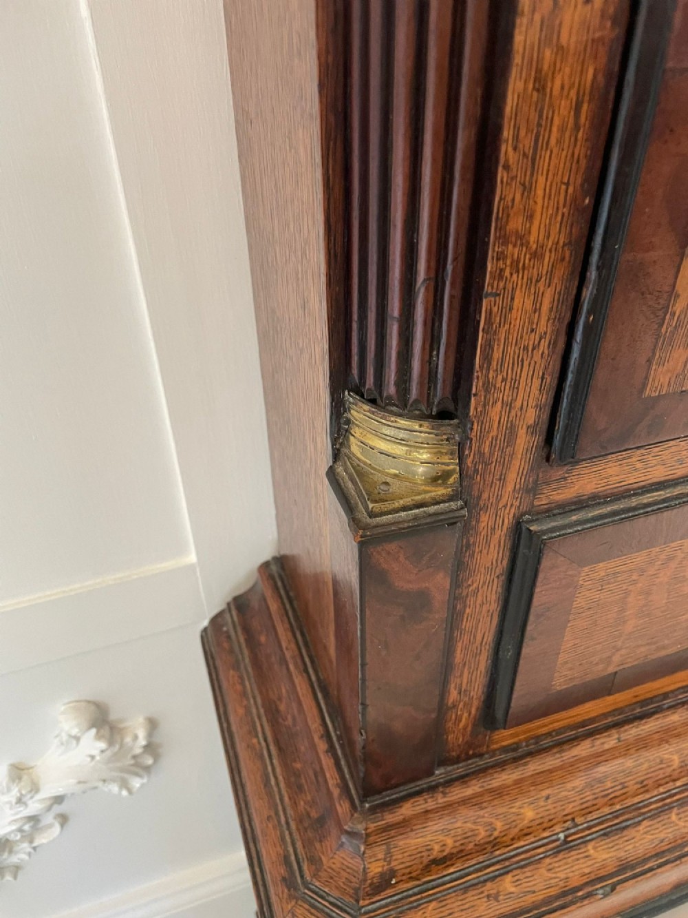 An antique George III oak and mahogany longcase clock with a swan-neck pediment, reeded columns, and a painted moon phase dial. View III