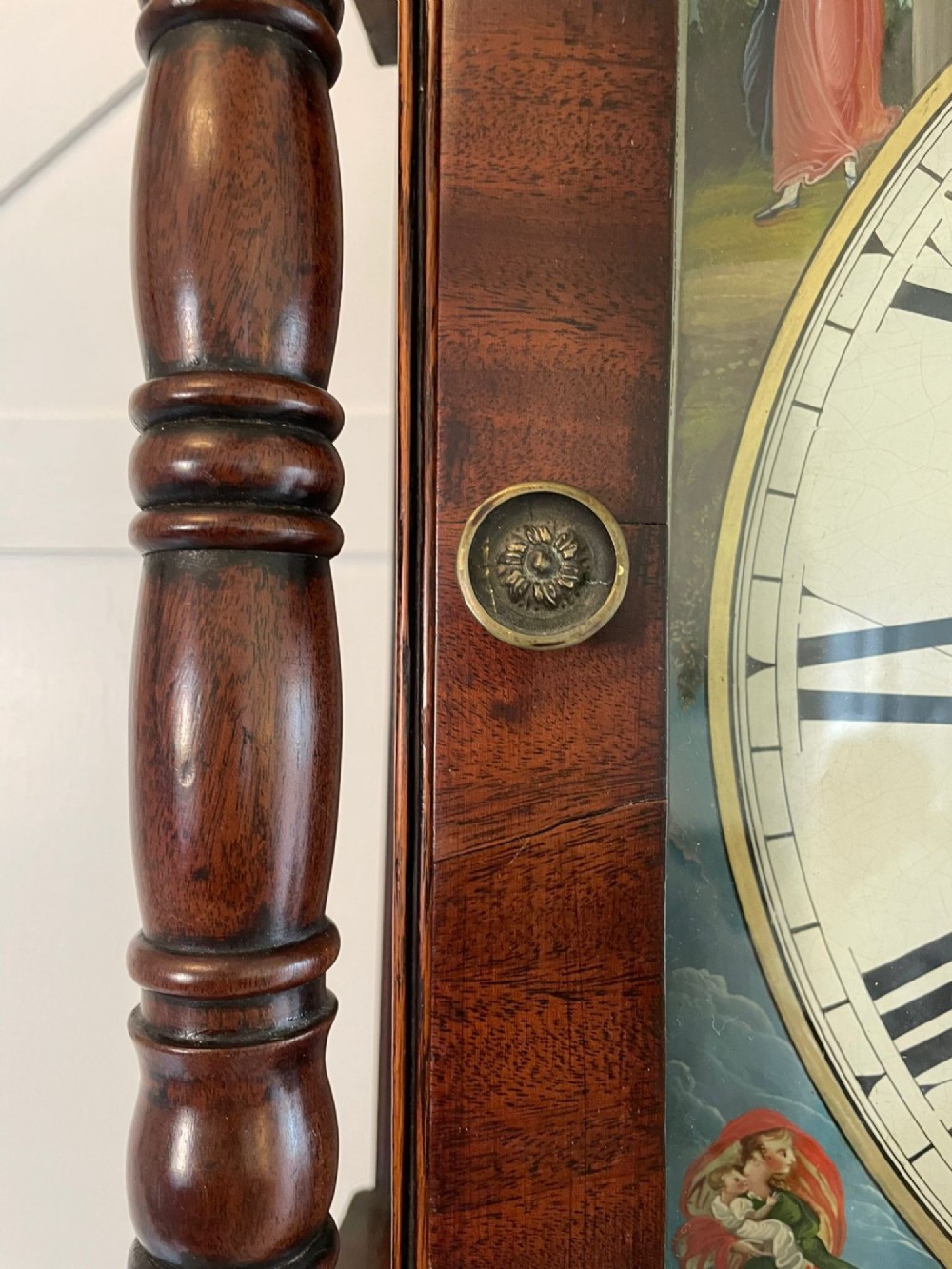 An antique George III oak and mahogany longcase clock with a swan-neck pediment, reeded columns, and a painted moon phase dial. View V