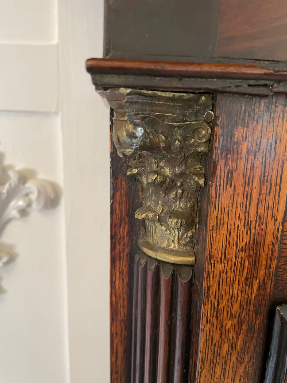 An antique George III oak and mahogany longcase clock with a swan-neck pediment, reeded columns, and a painted moon phase dial. View VI