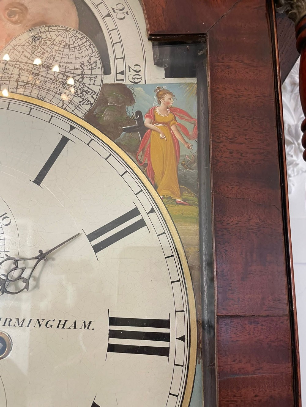 An antique George III oak and mahogany longcase clock with a swan-neck pediment, reeded columns, and a painted moon phase dial. View VIII