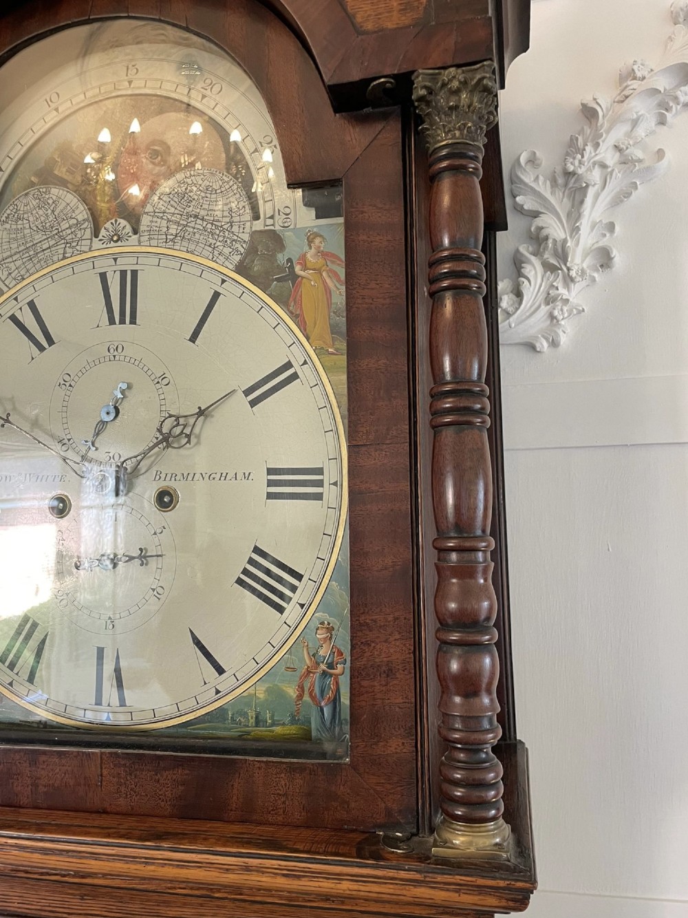 An antique George III oak and mahogany longcase clock with a swan-neck pediment, reeded columns, and a painted moon phase dial. View IX