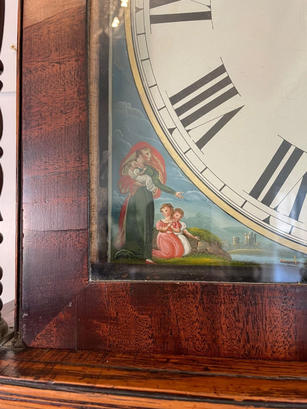 An antique George III oak and mahogany longcase clock with a swan-neck pediment, reeded columns, and a painted moon phase dial. View XI