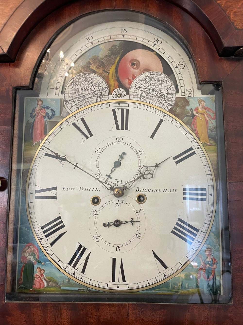 An antique George III oak and mahogany longcase clock with a swan-neck pediment, reeded columns, and a painted moon phase dial. View XIII