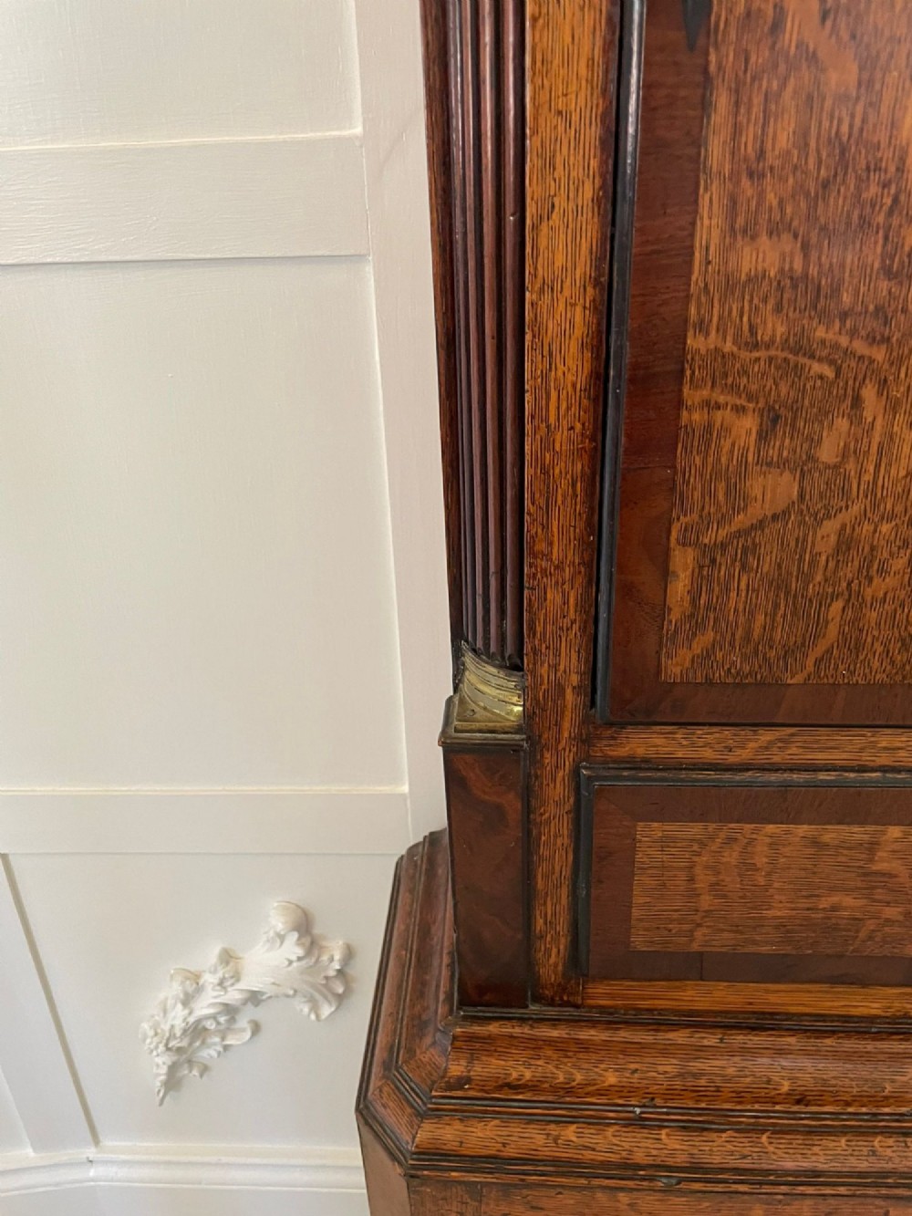 An antique George III oak and mahogany longcase clock with a swan-neck pediment, reeded columns, and a painted moon phase dial. View XV