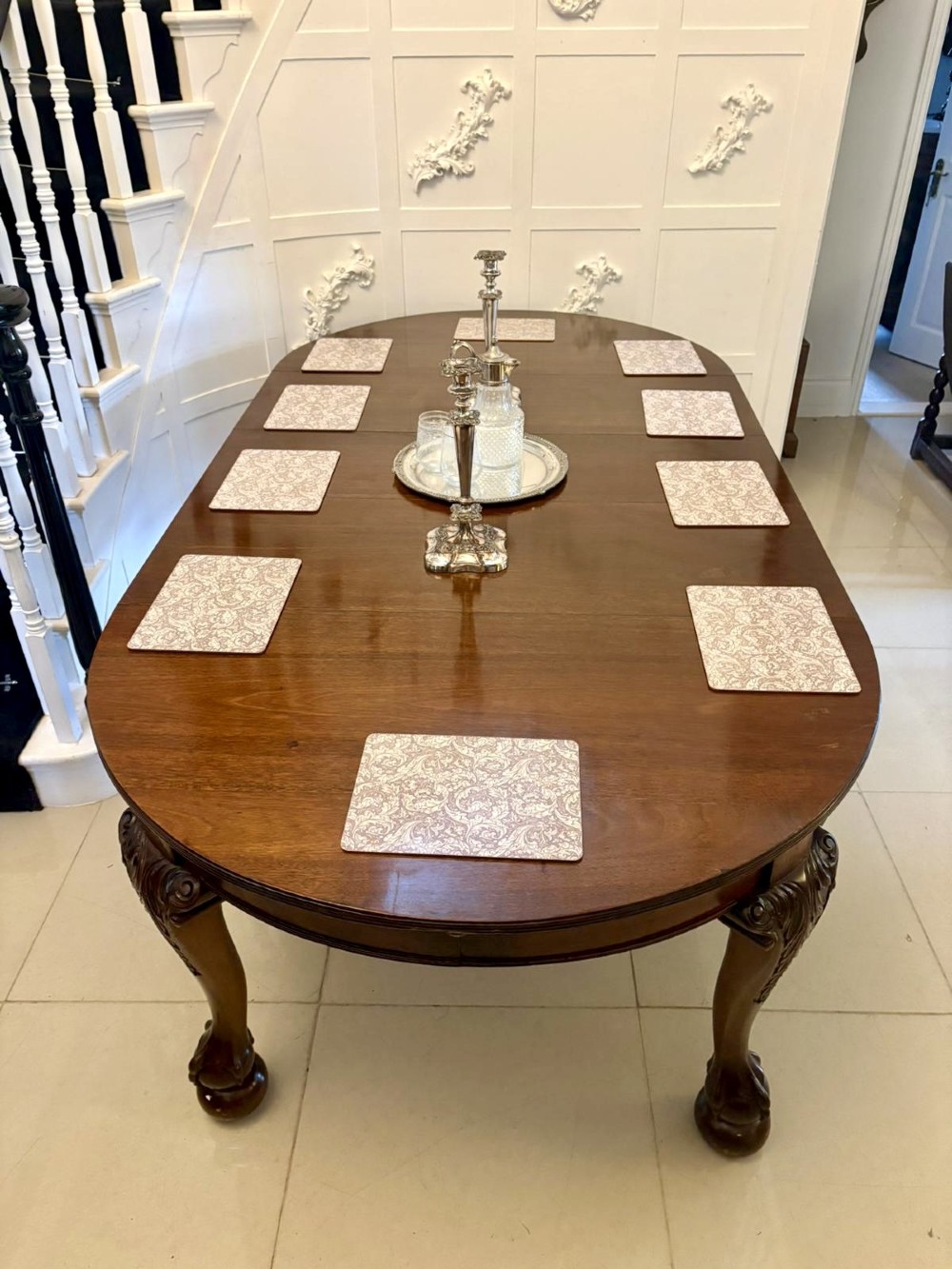 A large Victorian extending mahogany dining table featuring rounded ends and hand-carved cabriole legs with ball and claw feet. View IV