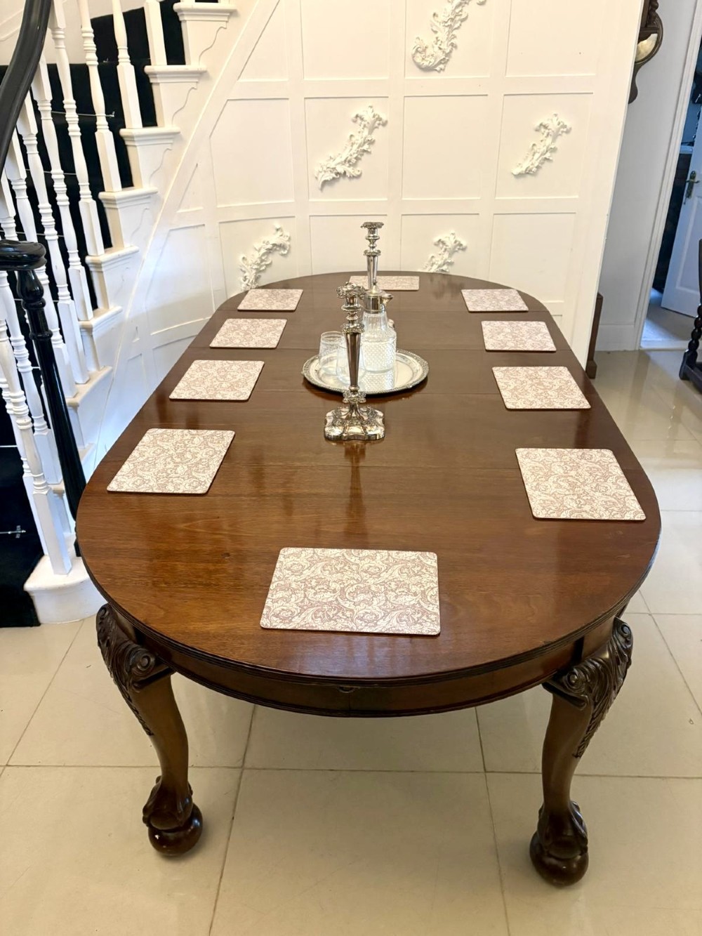 A large Victorian extending mahogany dining table featuring rounded ends and hand-carved cabriole legs with ball and claw feet. View V