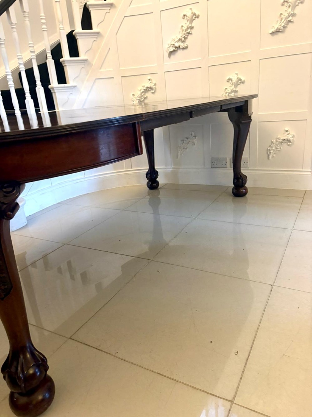 A large Victorian extending mahogany dining table featuring rounded ends and hand-carved cabriole legs with ball and claw feet. View VI