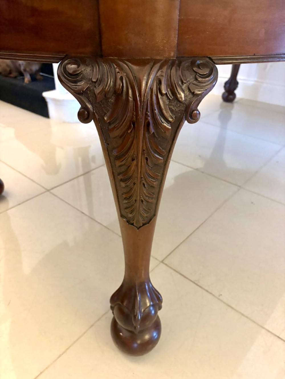 A large Victorian extending mahogany dining table featuring rounded ends and hand-carved cabriole legs with ball and claw feet. View X