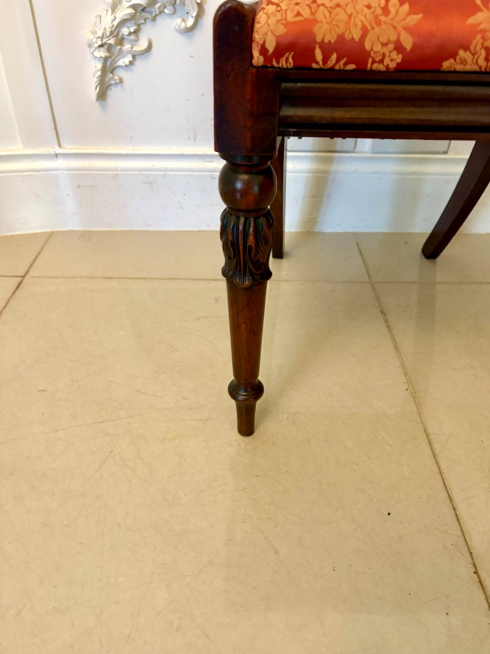 A set of six Regency carved rosewood dining chairs featuring curved backrests with scroll details, turned front legs, and pattern-upholstered seats. View VI