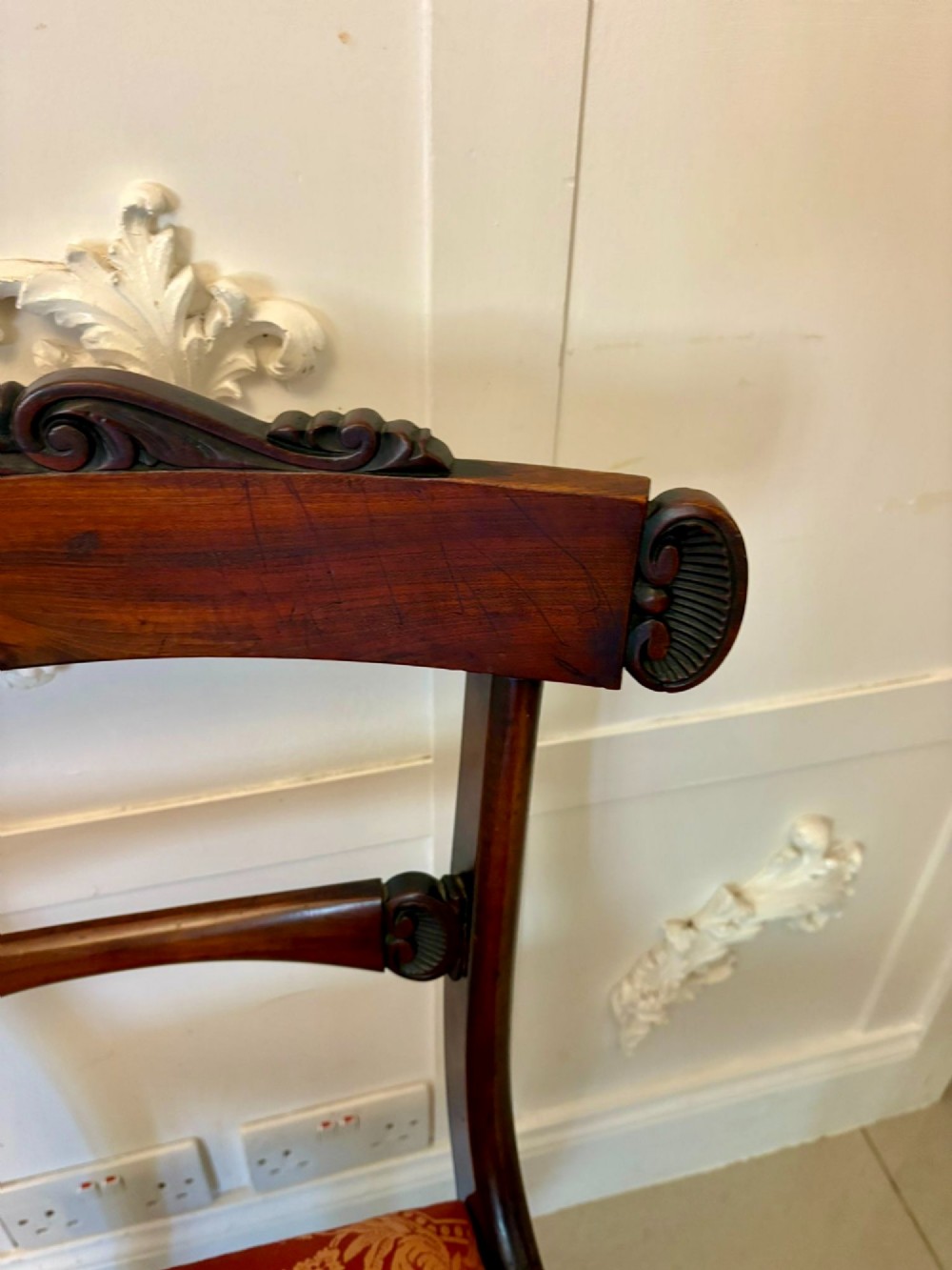 A set of six Regency carved rosewood dining chairs featuring curved backrests with scroll details, turned front legs, and pattern-upholstered seats. View XIII