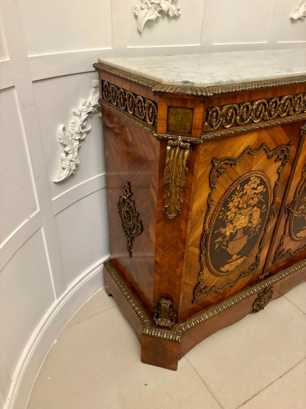 A French Louis XVI style wooden side cabinet featuring a white marble top, gilt-bronze mounts, and two door panels decorated with floral marquetry. View XII