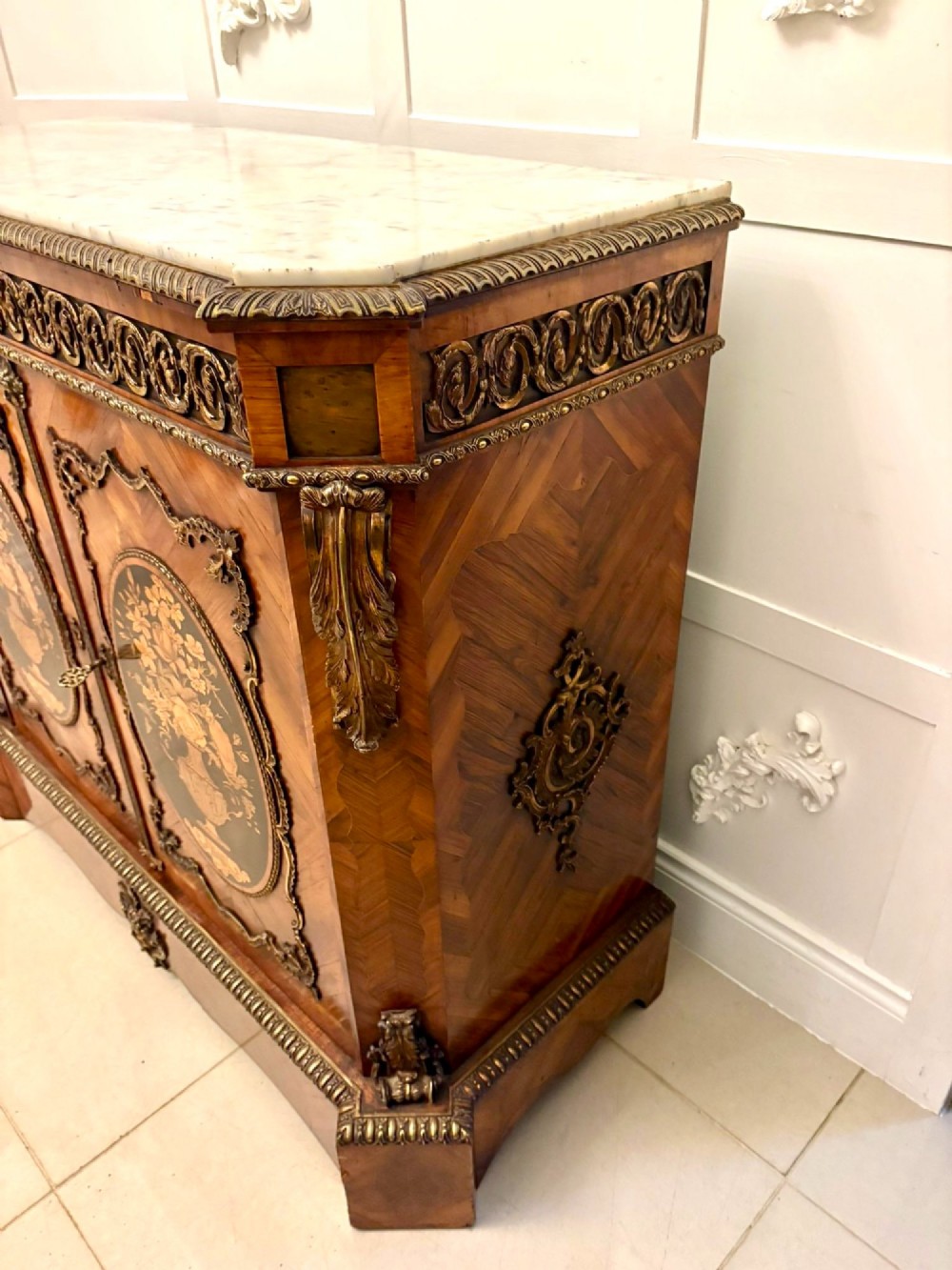 A French Louis XVI style wooden side cabinet featuring a white marble top, gilt-bronze mounts, and two door panels decorated with floral marquetry. View XIII