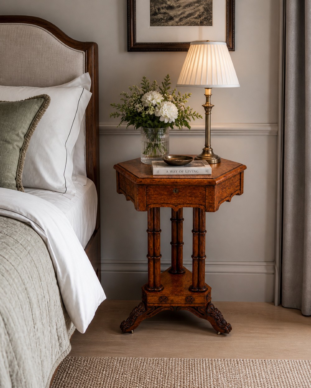 An antique Regency hexagonal pollard oak side table with turned column legs and a carved tripod base on castors. View II